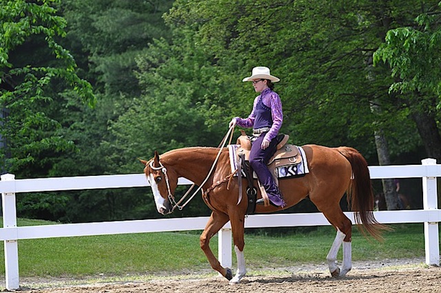Her flashy OTTB is very comfy in a Western saddle
