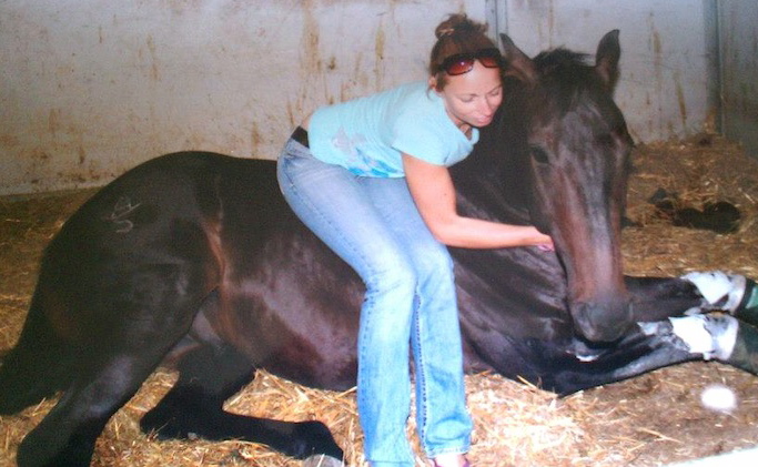 Lindsay White snuggles a favorite Quarter Horse who was lost in the Oklahoma tornado