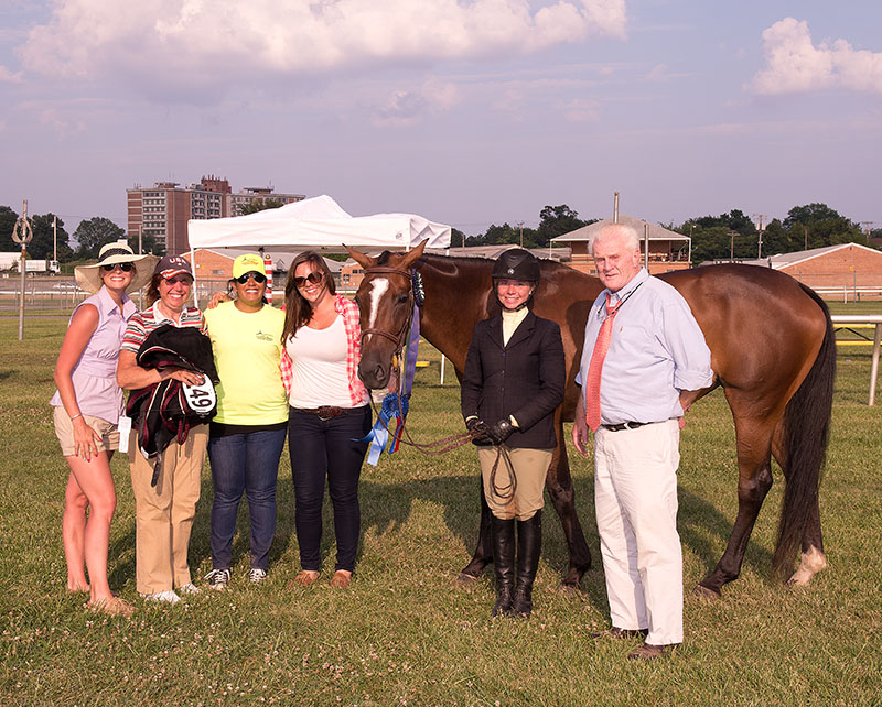Owner Sabrina Moore holds My Fantastic Lady, the winner of the 2014 Totally Thoroughbred Horse Show contested on the infield at Pimlico Race Course on Sunday. Courtney Sommers, who rode the mare, stands next to show judge Rodney Jenkins.  Photo by Jim McCue (Maryland Jockey Club)