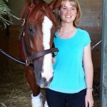 Kate Miller, Adoption Coordinator, CANTER Calif., poses with California Chrome in the halter.