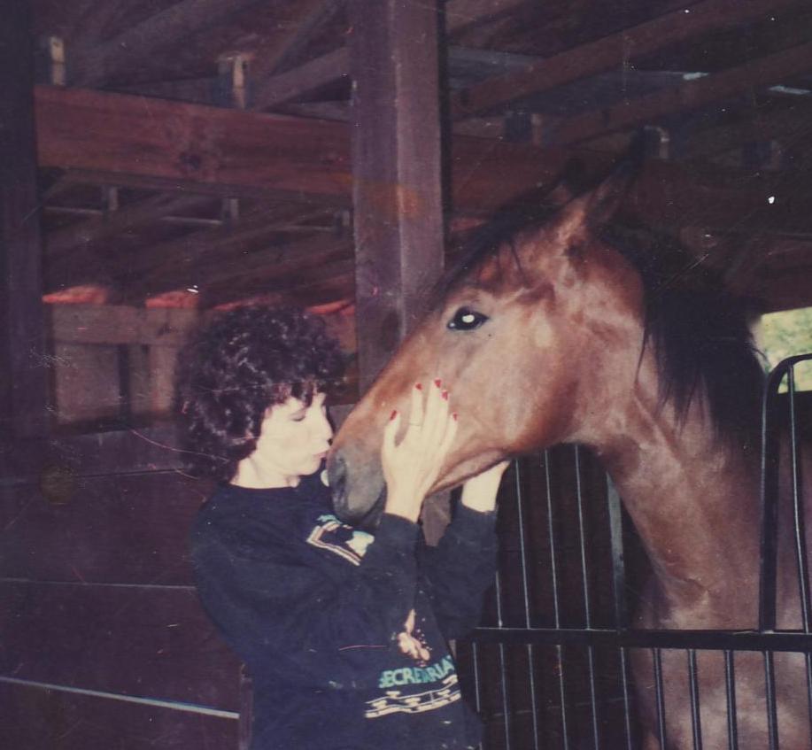 Jo Anne gives baby a kiss in this old photo, taken when he was a Yearling.