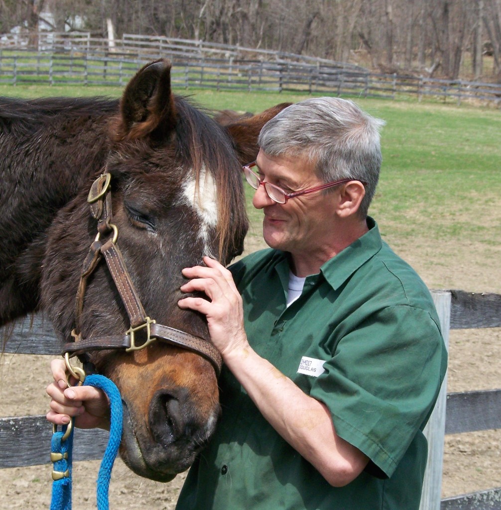 Sir Prize Birthday, who turns 35 in May, is the oldest retired racehorse in the Thoroughbred Retirement Foundation herd. He is pictured with inmate William Douglas. Photo by Jim Tremper