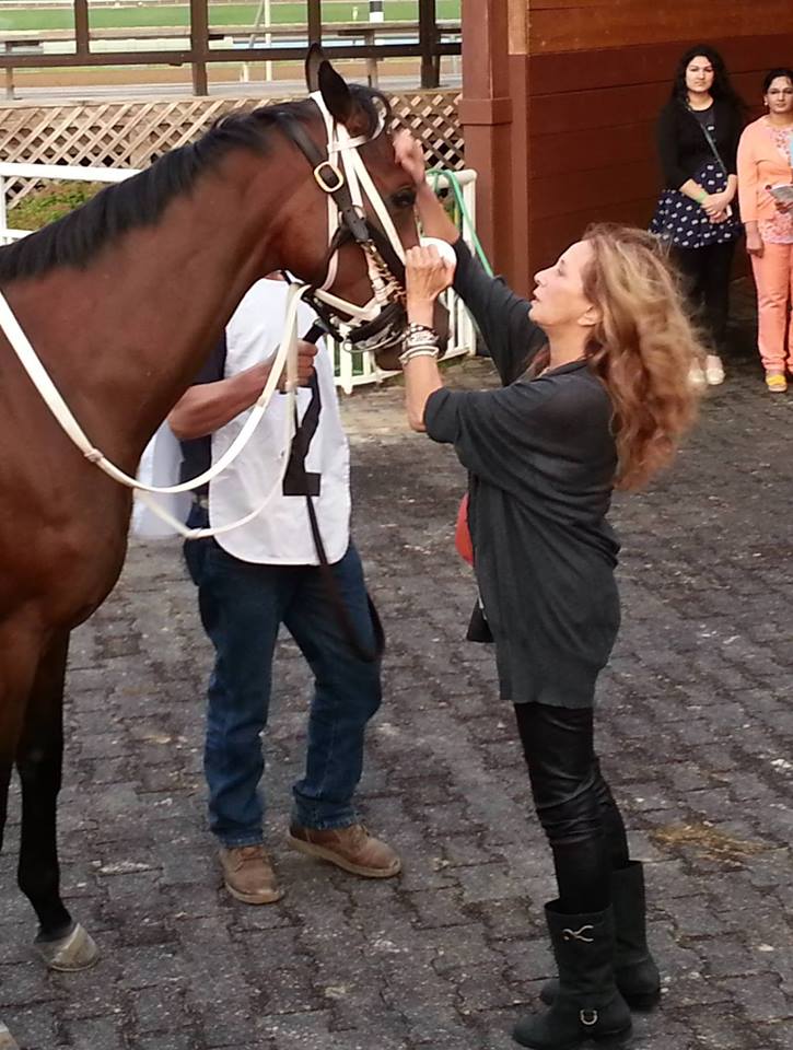Racehorse owner Maggi Moss, shown here with one of her Thoroughbreds, has begun pushing for an investigation into what happened to a gelding discovered in a La. lot this week.