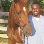Tim Brooks, a graduate of the Thoroughbred Retirement Foundation's Second Chances program, has gone to work for Steuart Pittman of the Retired Racehorse Project. Pictured with Reds, an OTTB who changed his life.