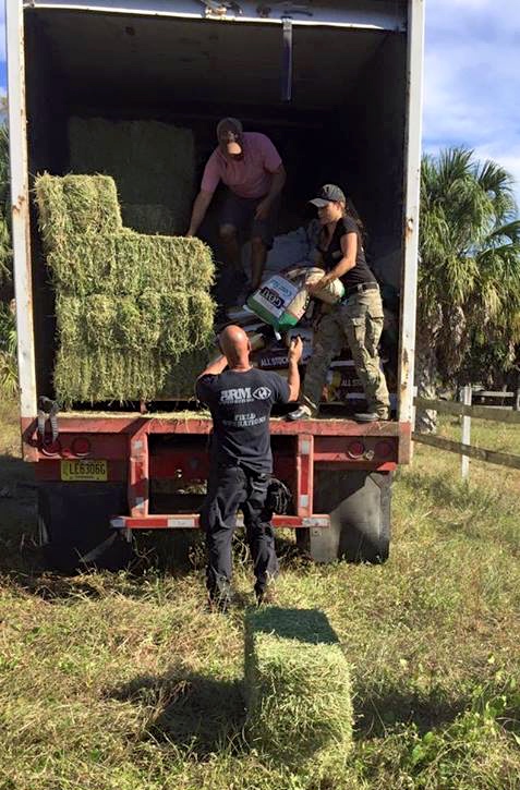 Couto unloads donated feed given to help feed the animals rescued last week in the Florida sweep.