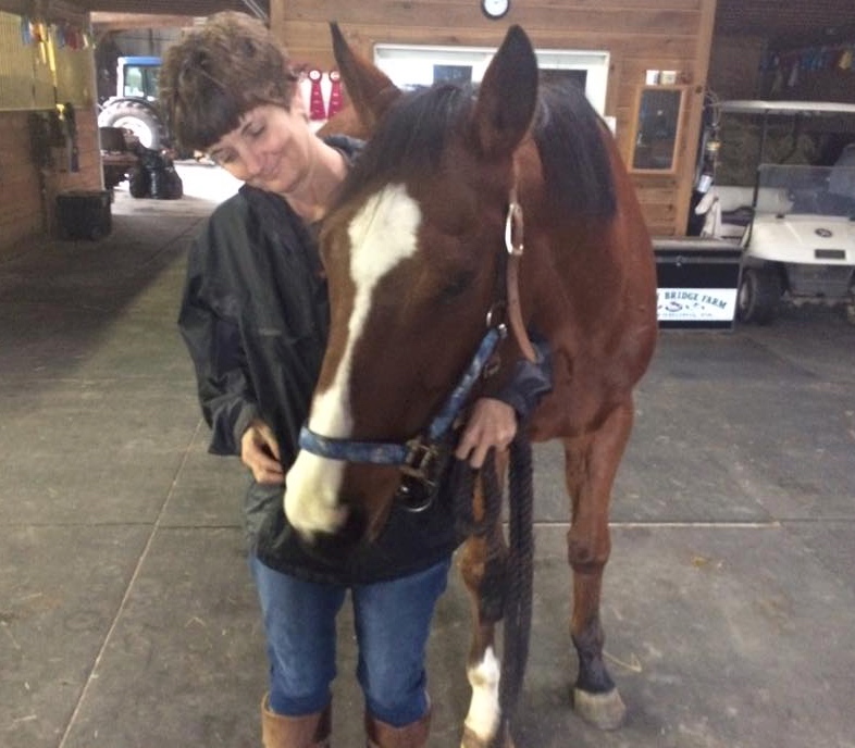 Metro Meteor's eyes appear to be improving. Here he enjoys a moment with owner Wendy Krajewski.