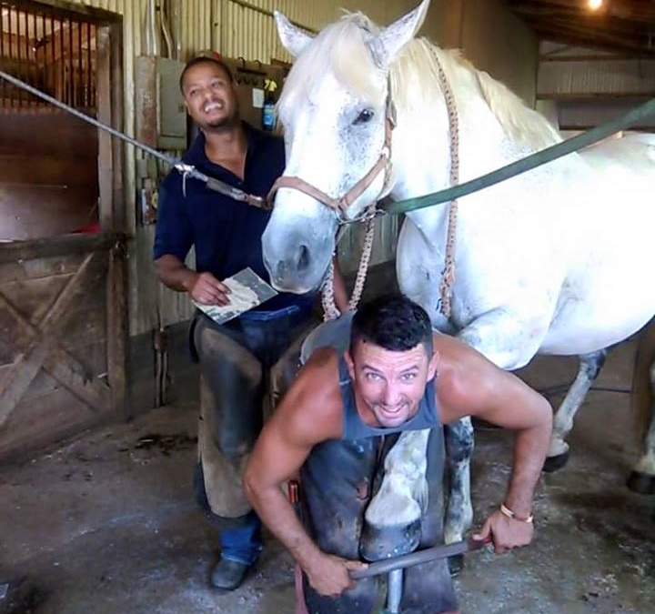 Holmes, in the back, says working with horses turned his life around after prison.
