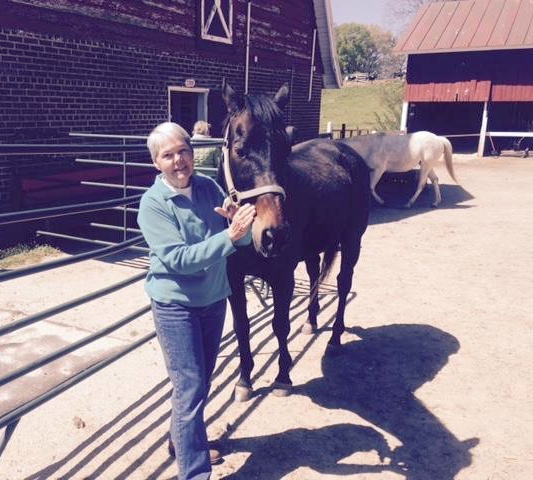 Anne Tucker, pictured with Thoroughbred Retirement Foundation retiree Covert Action, says she was deeply touched by a generous donation from high school students.