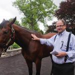 New York Times award-winning journalist Joe Drape shares a moment with Triple Crown winner American Pharoah.