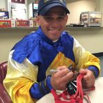 Hall of Fame jockey John Velazquez signs goggles to be raffled during Black Eyed Susan and Preakness stakes to raise funds for Thoroughbreds and permanently disabled jockeys.