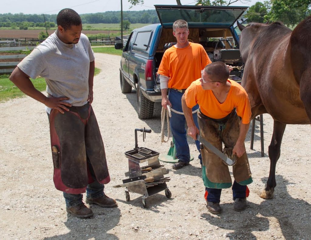 William Wilson, with horse, forged a new career while learning the artistry of horse shoeing at the Thoroughbred Retirement Foundation's Second Chances program. Photo courtesy Anne Tucker